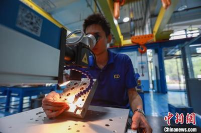 5月16日,在河北省邯郸市邯山区金大智能科技项目模具组装中心,工作人员正在对模具配件进行激光修复。 李昊 摄